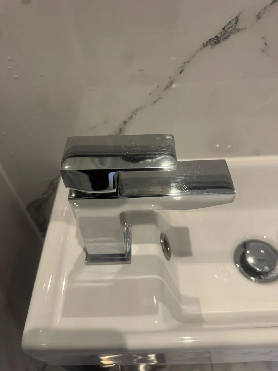 The same bathroom tap and basin after cleaning
